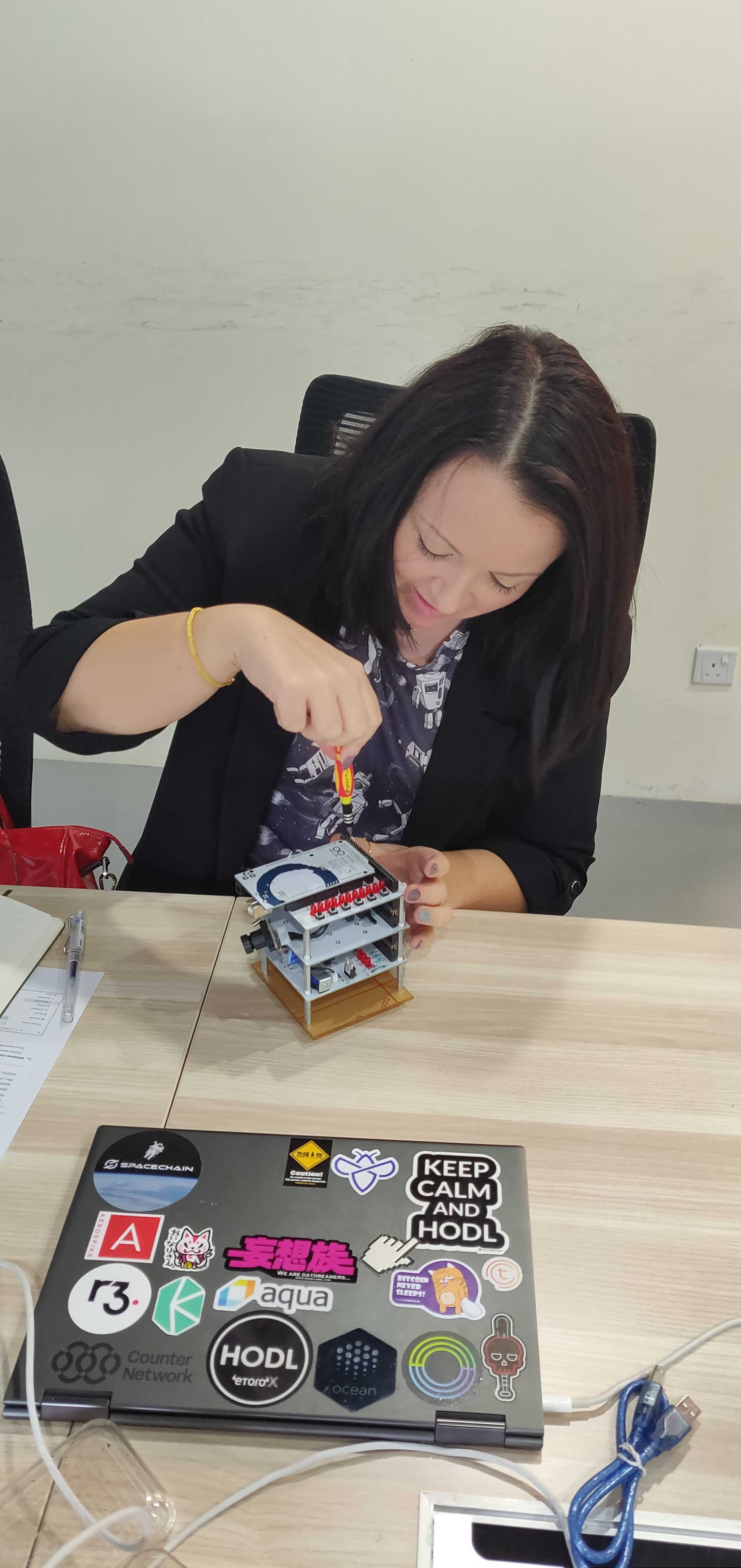 Alex Albano assembling a nanosatellite